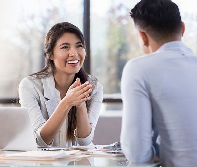 Smiling woman in a meeting with another person