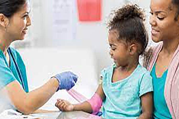 pediatric nurse treating patient in urgent care clinic